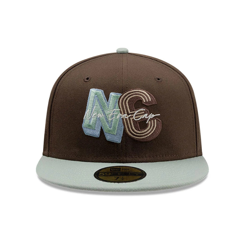 New Era DIY Note Dark Brown 59FIFTY Fitted Cap, front view showing raised NC embroidery in green and brown with a New Era signature script, paired with a contrasting light green flat visor and a centred gold 59FIFTY size sticker.