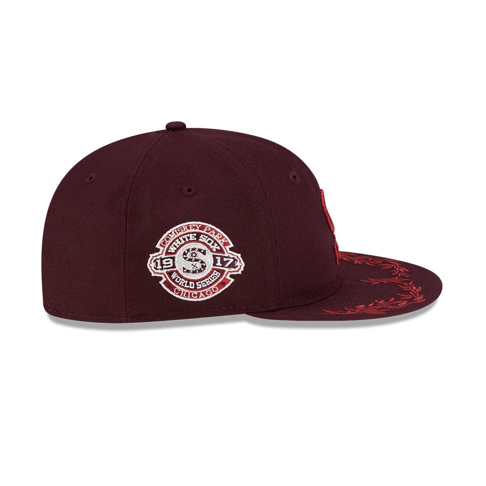 Chicago White Sox MLB Flourishes Purple Retro Crown New Era 9FIFTY Cap, side view showing the embroidered Wrigley Park 1917 World Series patch on the mid panel, a flat visor with red decorative flourishes, and a maroon structured crown.
