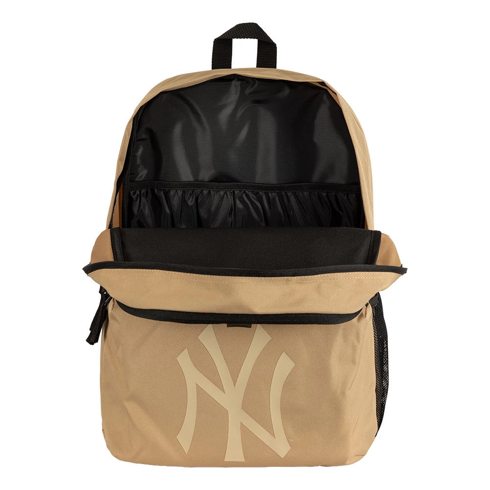 New Era New York Yankees MLB Light Beige Stadium Backpack, open view showing the large main compartment with a black interior, a front panel adorned with an oversized beige New York Yankees logo, and a top carrying handle.