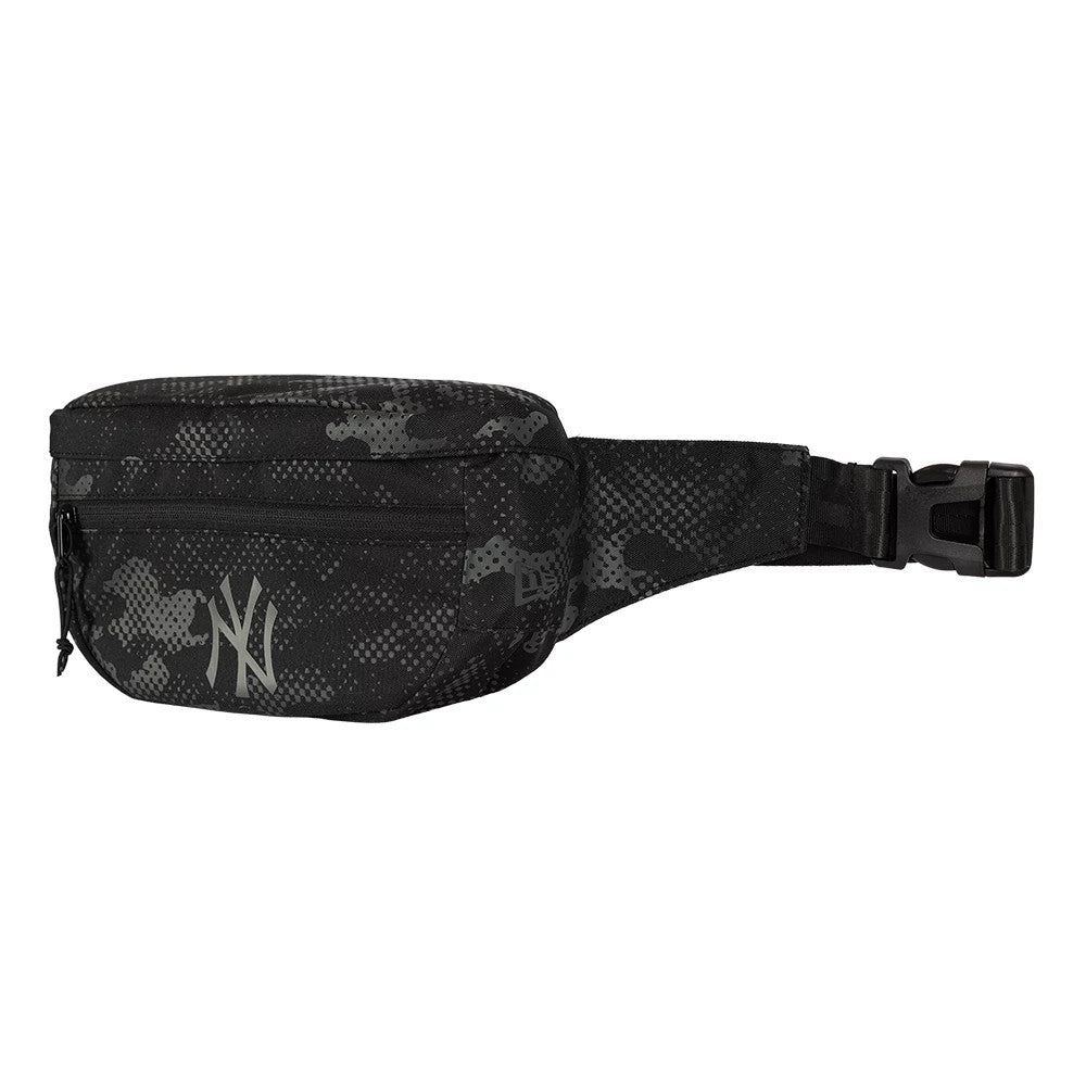 New Era New York Yankees MLB Camo Black Waist Bag, side view showing the black camouflage pattern with a raised New York Yankees logo on the front pocket, a small zip pull, and a buckle closure attached to the black adjustable waist strap.