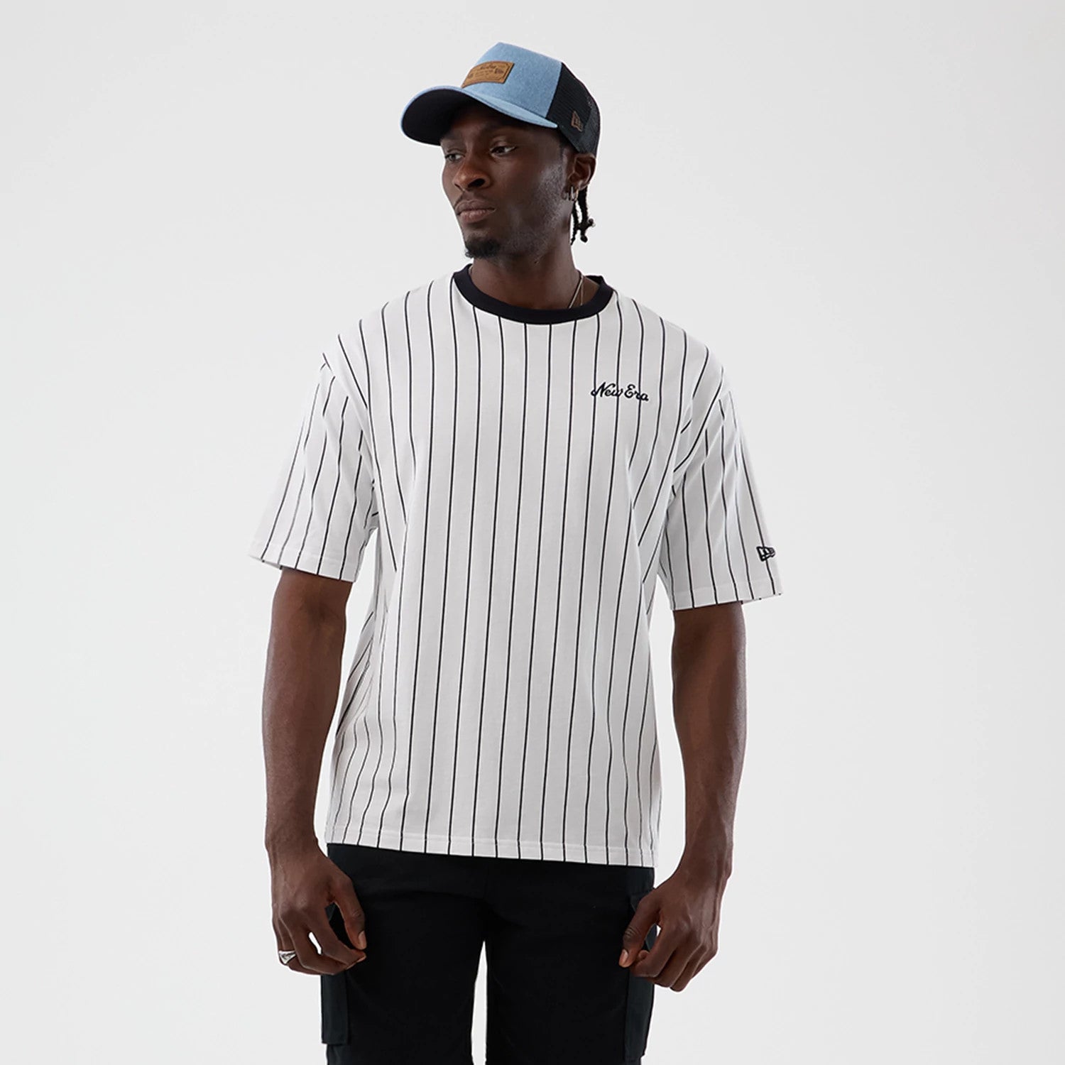 The model is wearing this New Era Pinstripe Oversized T-Shirt in Open White. 1