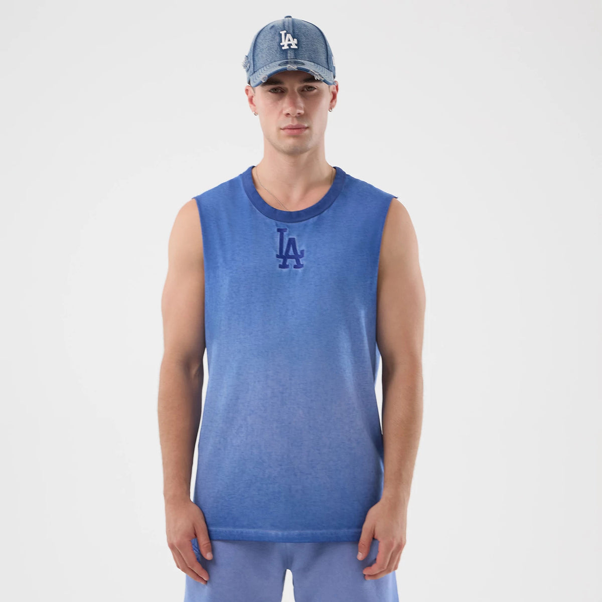 New Era LA Dodgers MLB Washed Logo Pastel Blue Vest, front view on a model wearing a matching cap, displaying the distinctive LA logo in dark blue embroidery on the chest with a gradient colour effect on the sleeveless vest.
