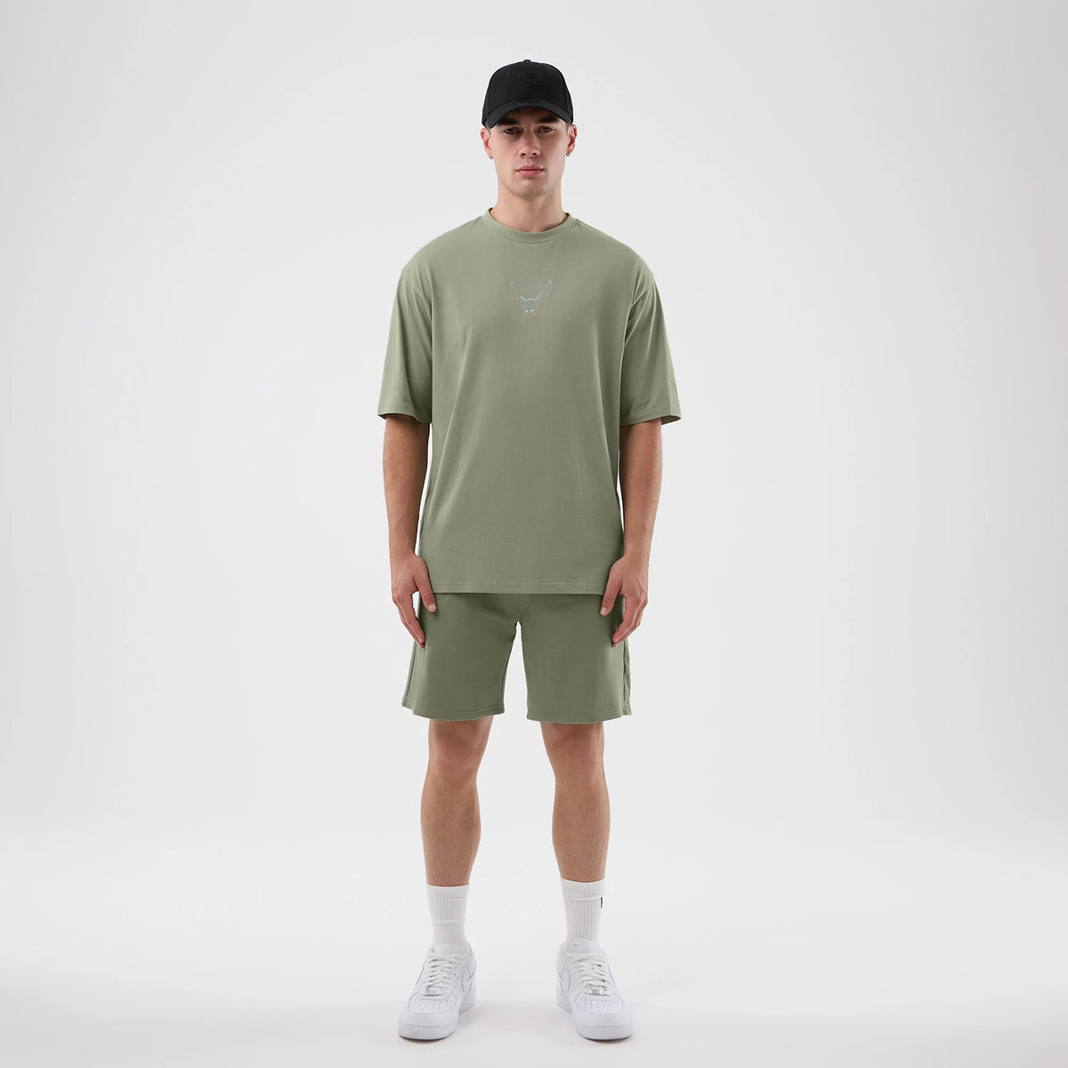 New Era Chicago Bulls NBA League Essential Pastel Green Oversized T-Shirt, front view on a model paired with shorts, featuring a printed Chicago Bulls logo in the centre of the chest, short sleeves, and a relaxed oversized fit.