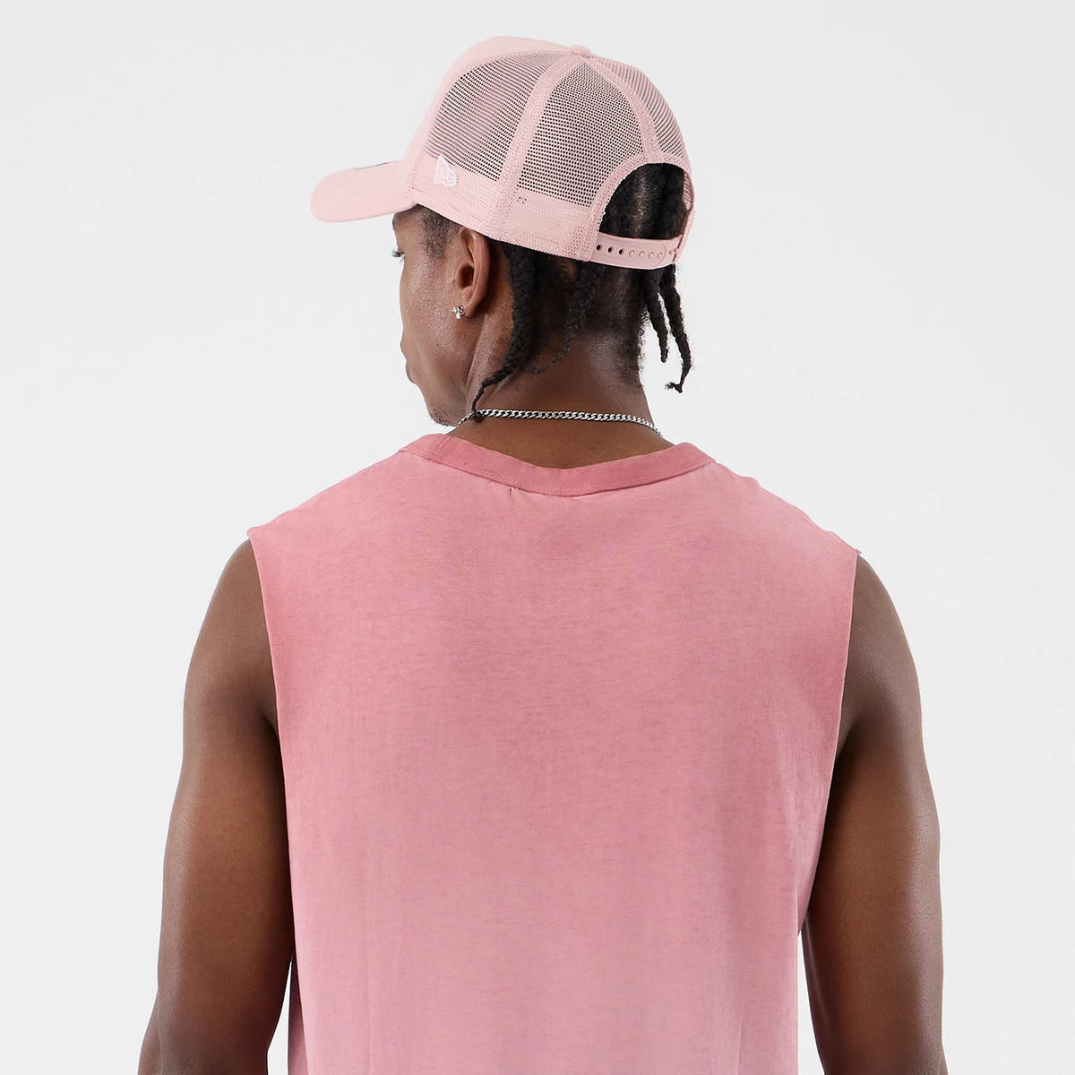New Era New York Yankees MLB Washed Logo Pastel Pink Vest, back view on a model wearing a matching pastel pink mesh-back cap, showing a sleeveless design with raw edges and a slightly faded finish that offers a casual, relaxed fit.