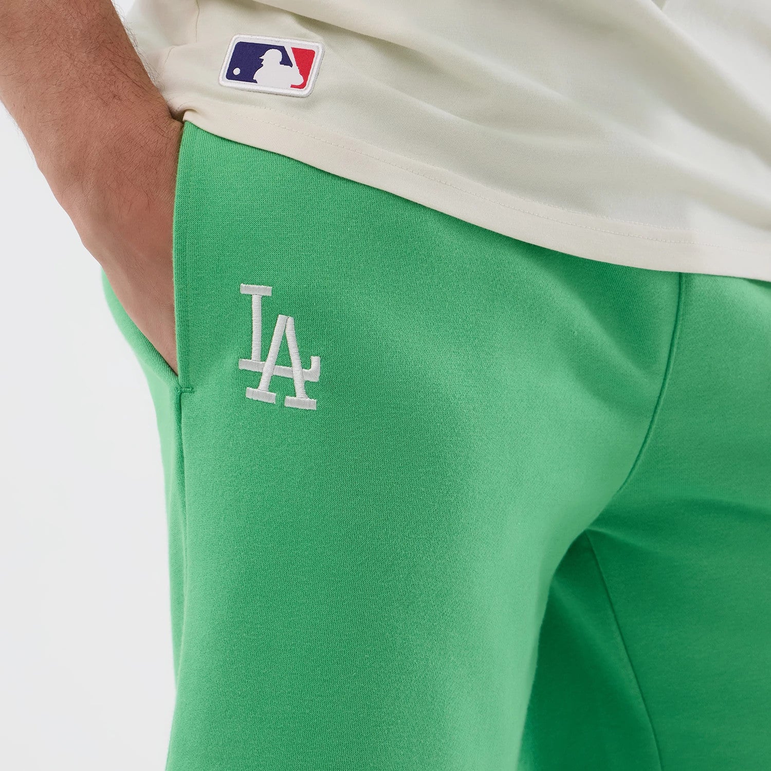 The model is wearing this MLB League Essential LA Dodgers Shorts in open green. 4