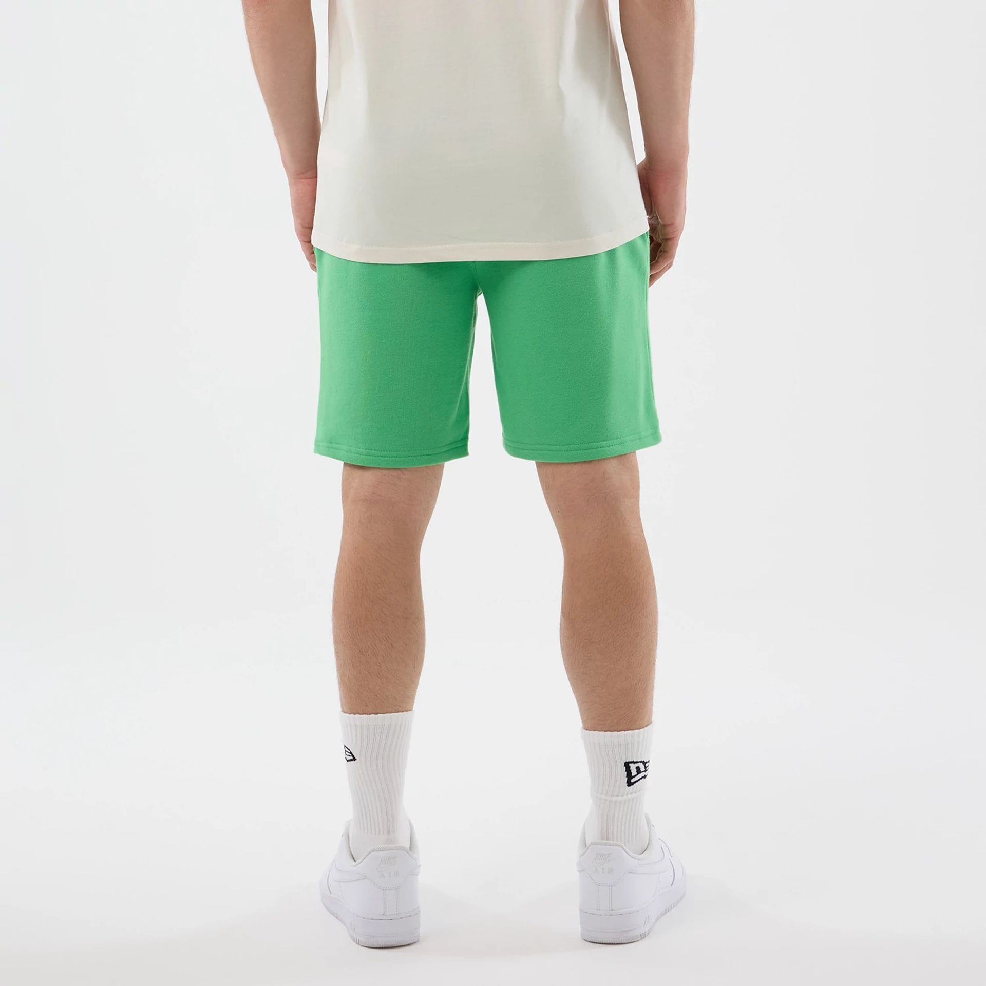 The model is wearing this MLB League Essential LA Dodgers Shorts in open green. 2
