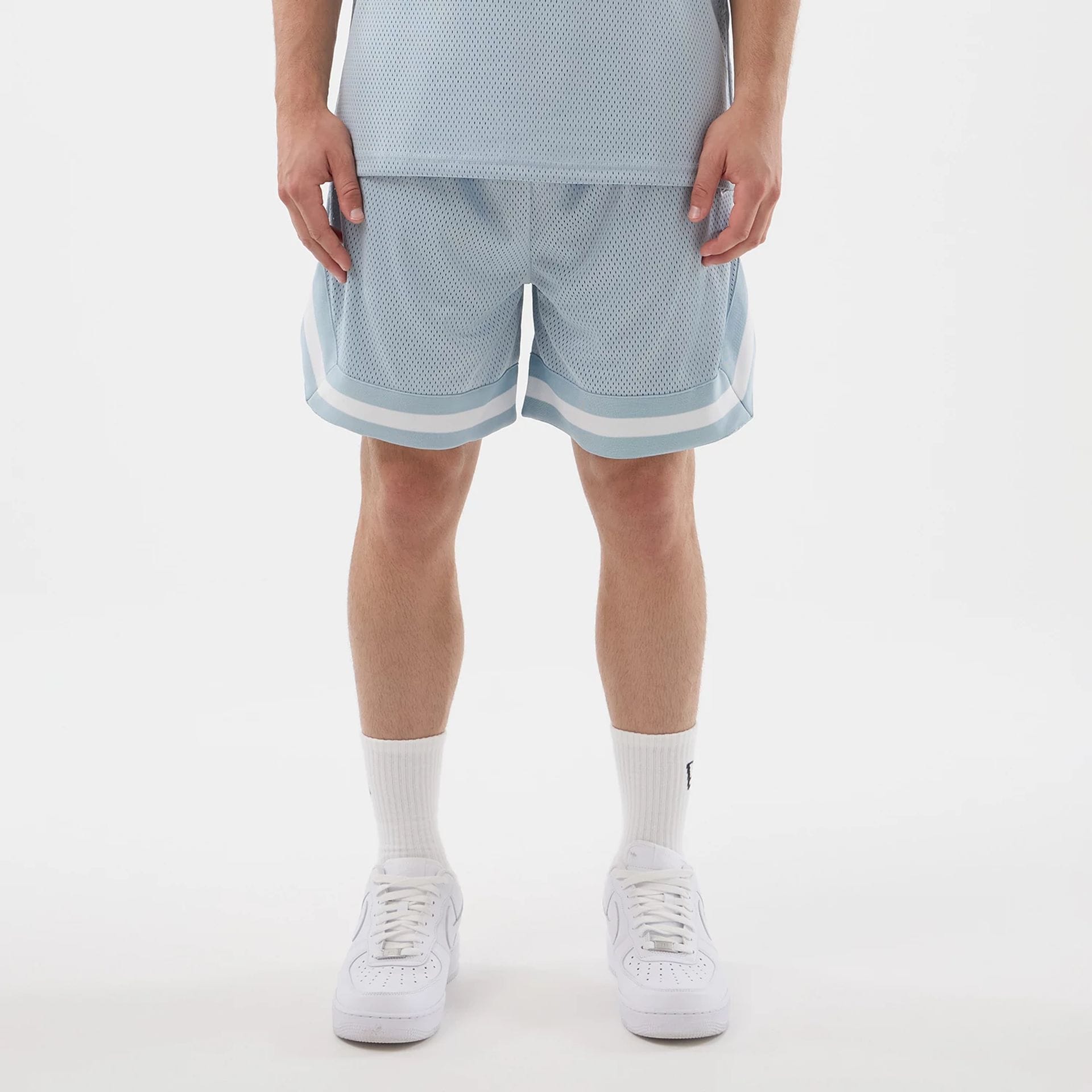 The model is wearing this New Era Mesh Oversized Shorts in pastel blue. 1