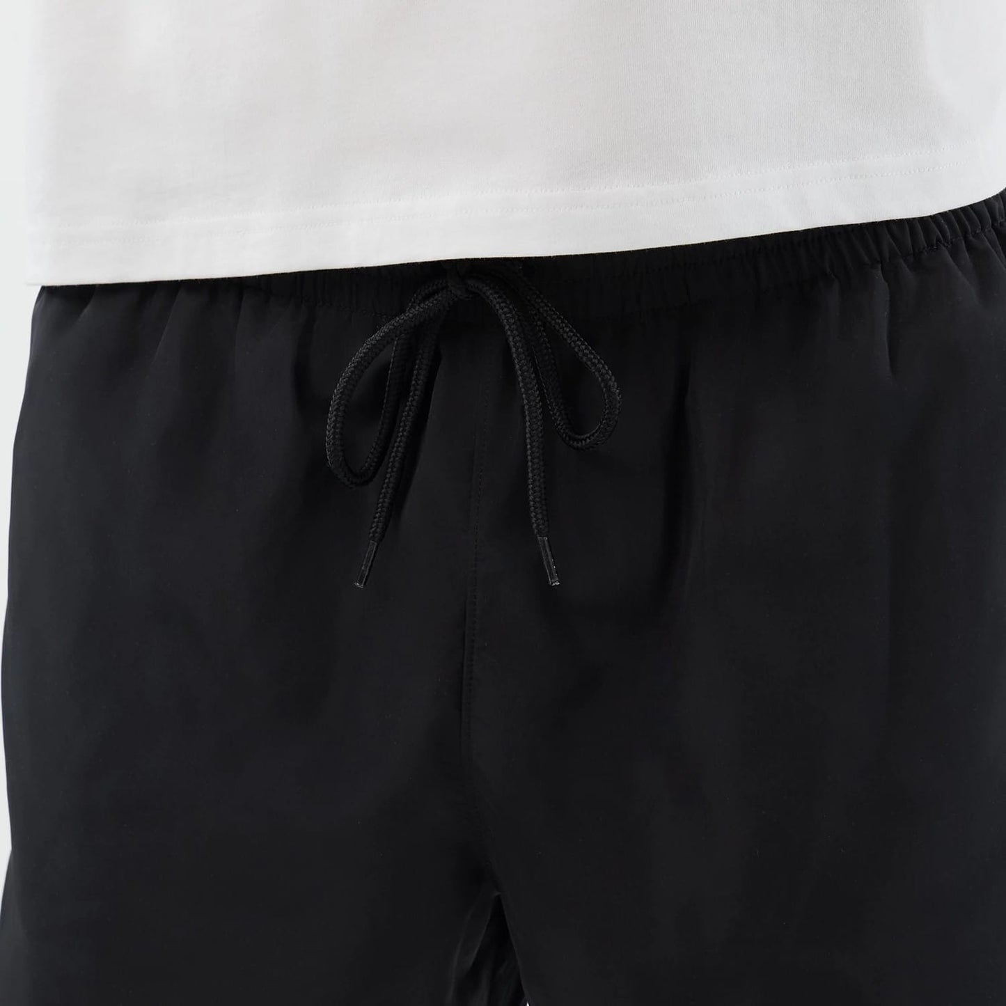 The model is wearing this New Era Swimming Shorts in black. 7