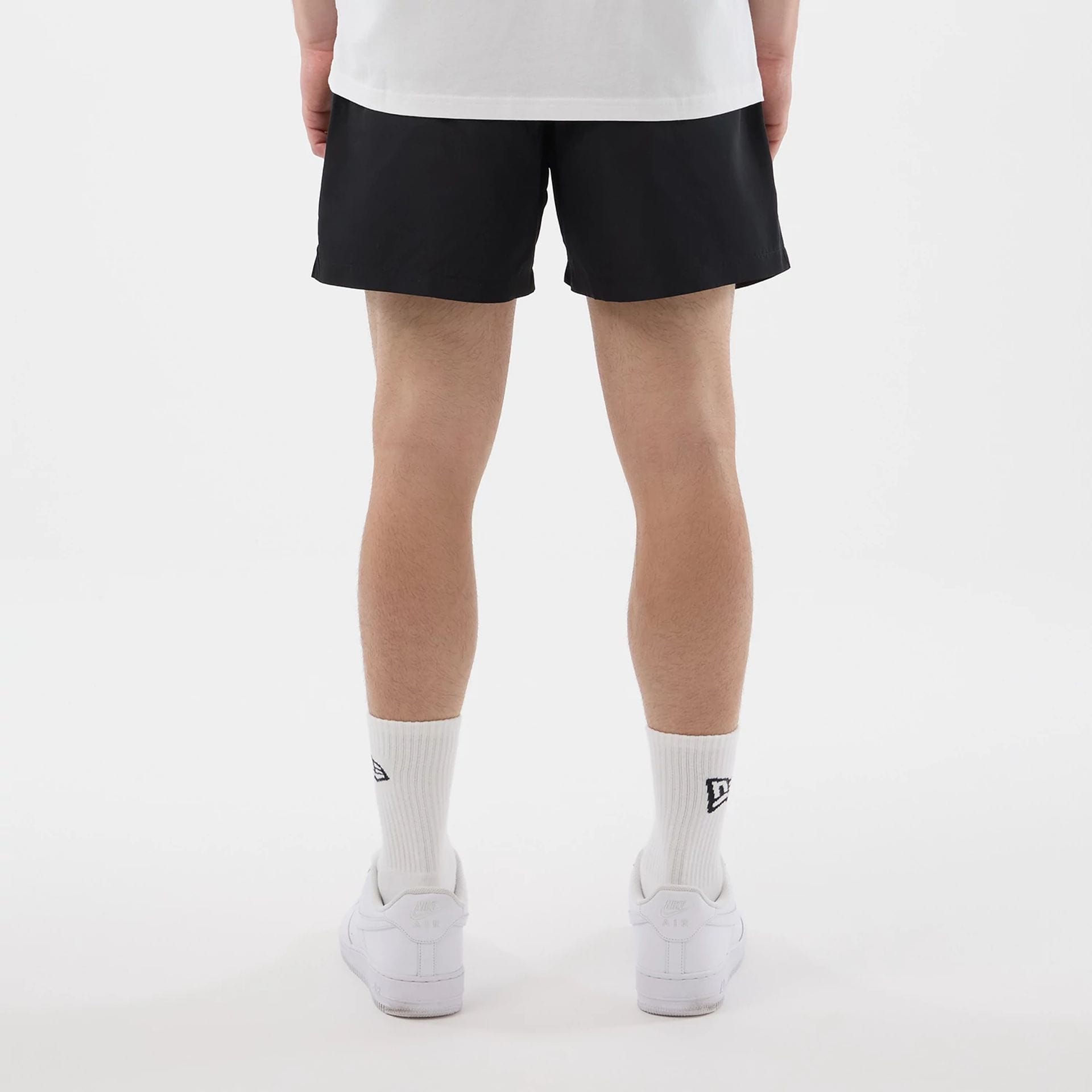 The model is wearing this New Era Swimming Shorts in black. 2