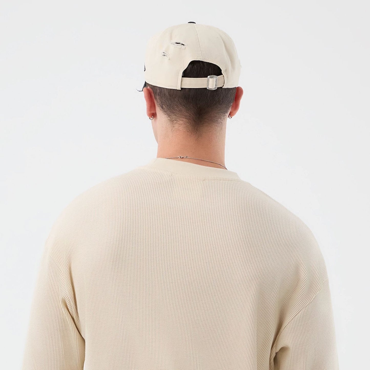 The model is wearing this New Era Waffle T-Shirt in light beige. 8