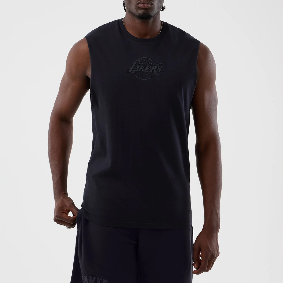 New Era LA Lakers NBA Core Plus Navy Vest, front view on a model showing the Los Angeles Lakers logo on the chest, the sleeveless cut with wide arm openings, and the long, relaxed fit extending past the waist.