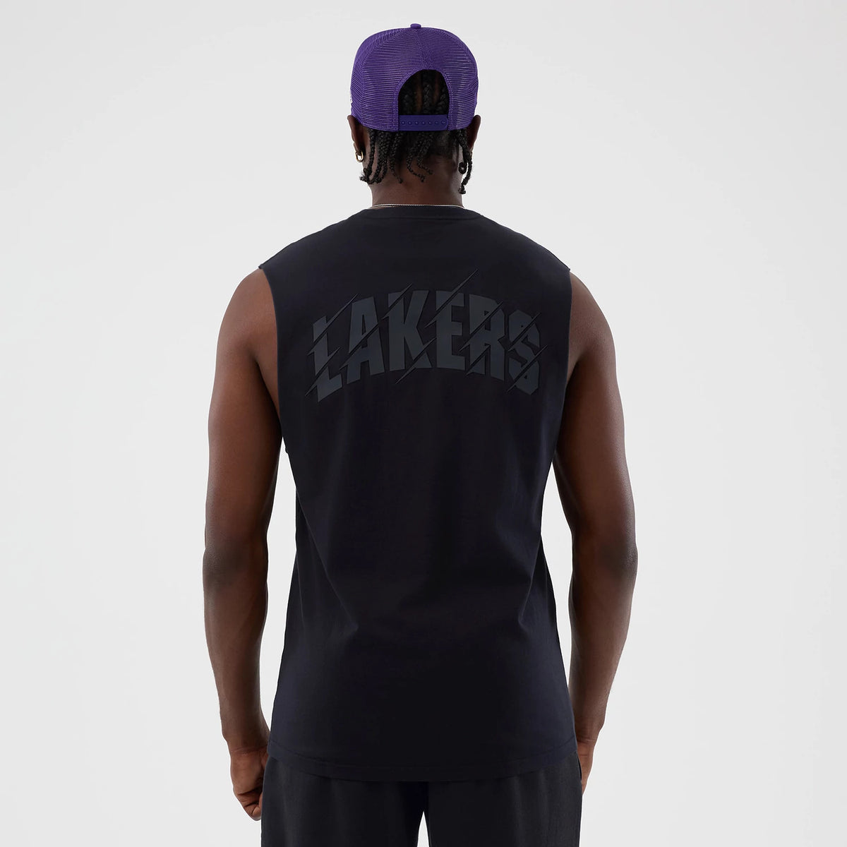 New Era LA Lakers NBA Core Plus Navy Vest, back view on a model with a purple mesh cap, featuring large Laker graphics centred on the upper back, and sleeveless design for a relaxed fit.