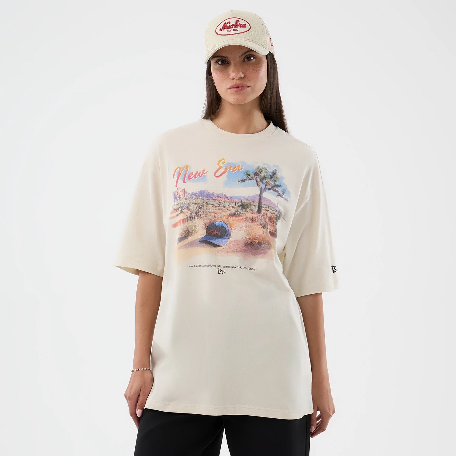 The model is wearing this New Era Dessert Graphic Oversized T-Shirt in light beige. 4