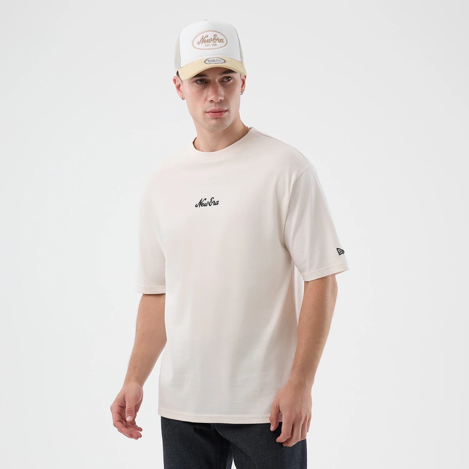 The model is wearing this New Era Floral Graphic Oversized T-Shirt in open white. 3