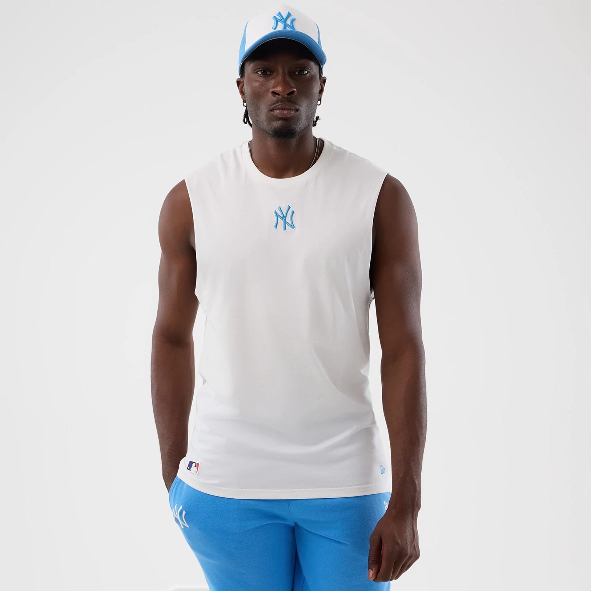 The model is wearing this MLB League Essential New York Yankees Vest in white. 1