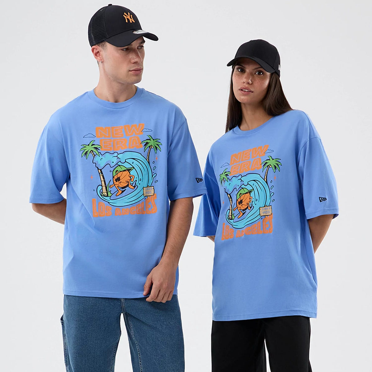The model is wearing this New Era Basketball Character Graphic T-Shirt in pastel blue. 1