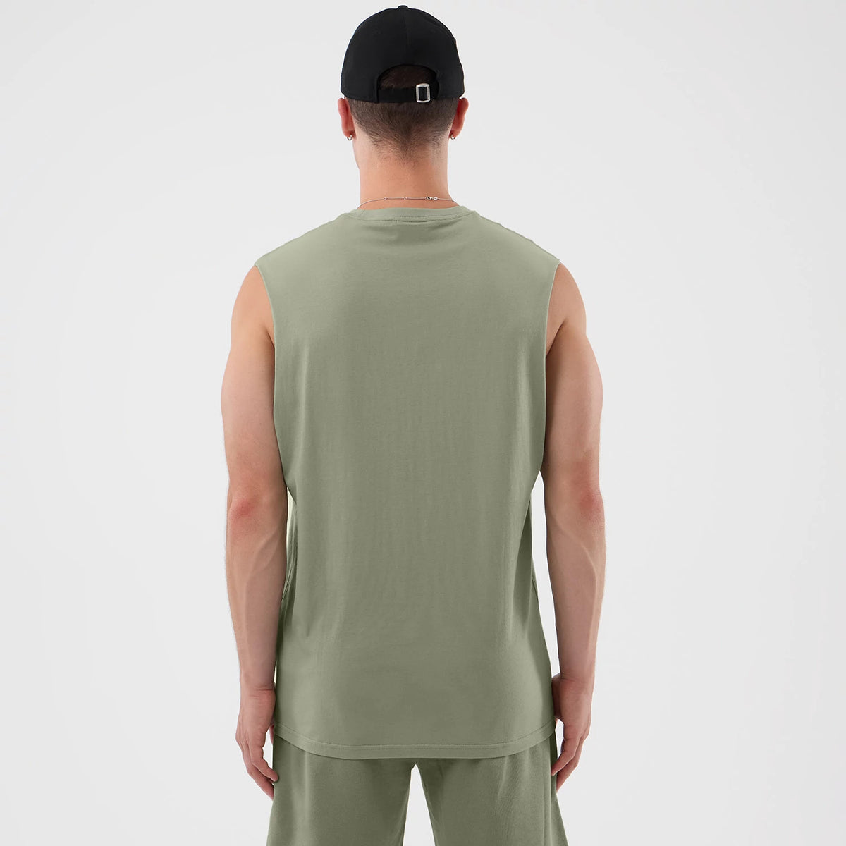 New Era Chicago Bulls NBA League Essential Pastel Green Vest, back view on a model wearing a black cap, showcasing the sleeveless design and relaxed fit of the pastel green fabric.