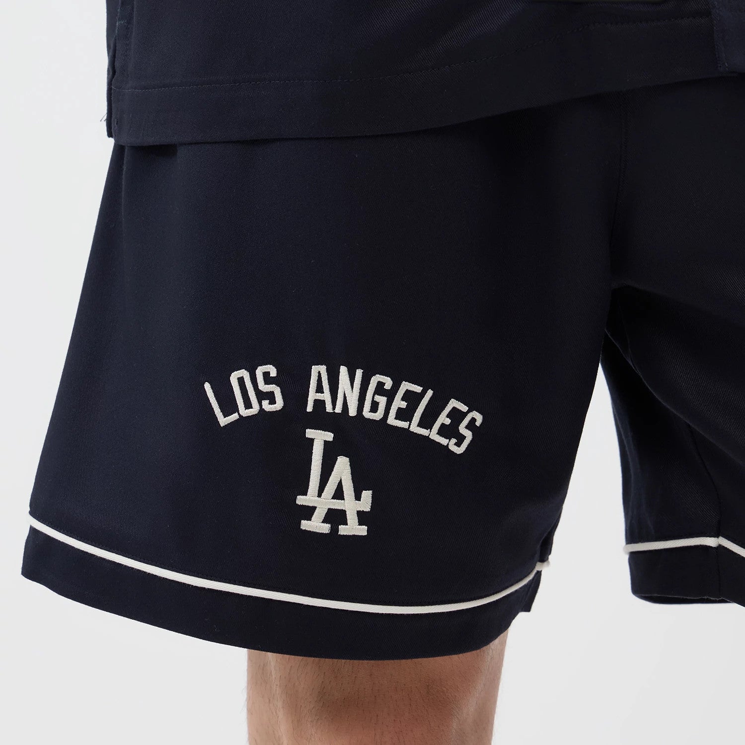 The model is wearing this MLB Woven LA Dodgers Shorts in navy. 4