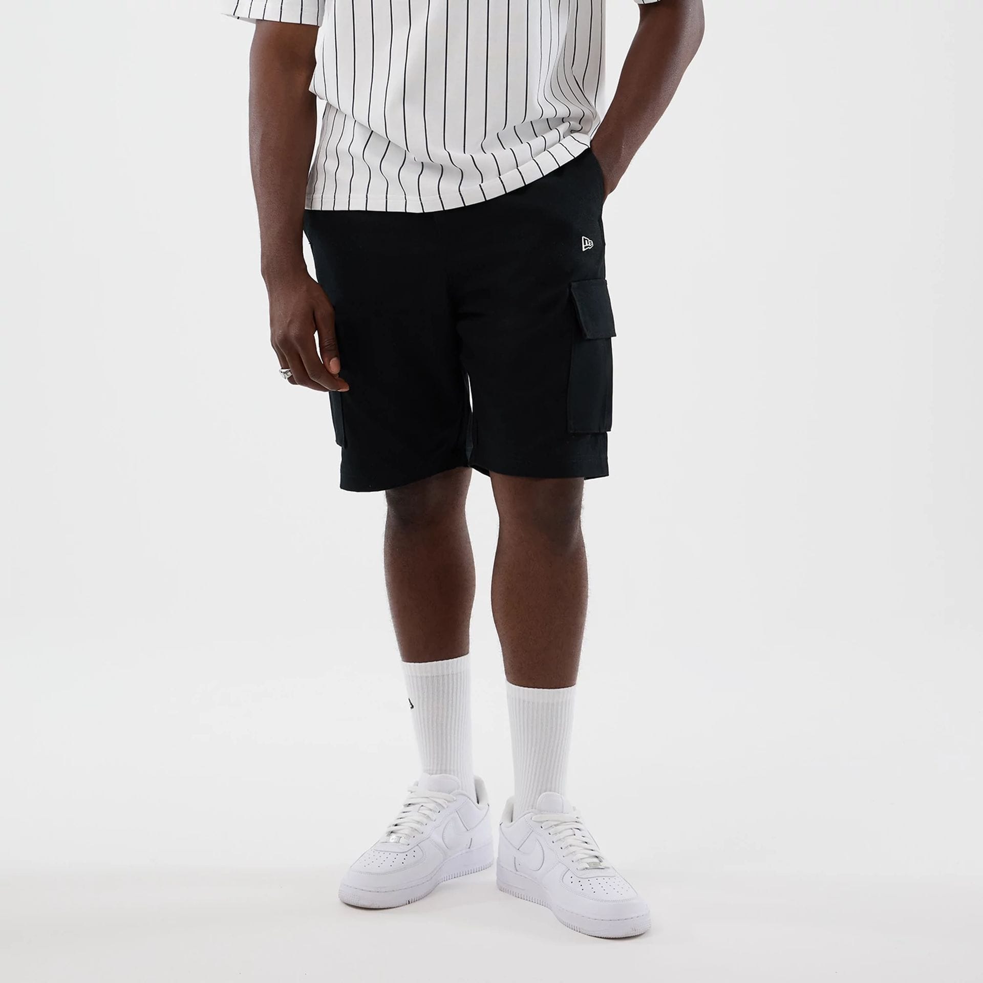 The model is wearing this New Era Cargo Shorts in black. 1