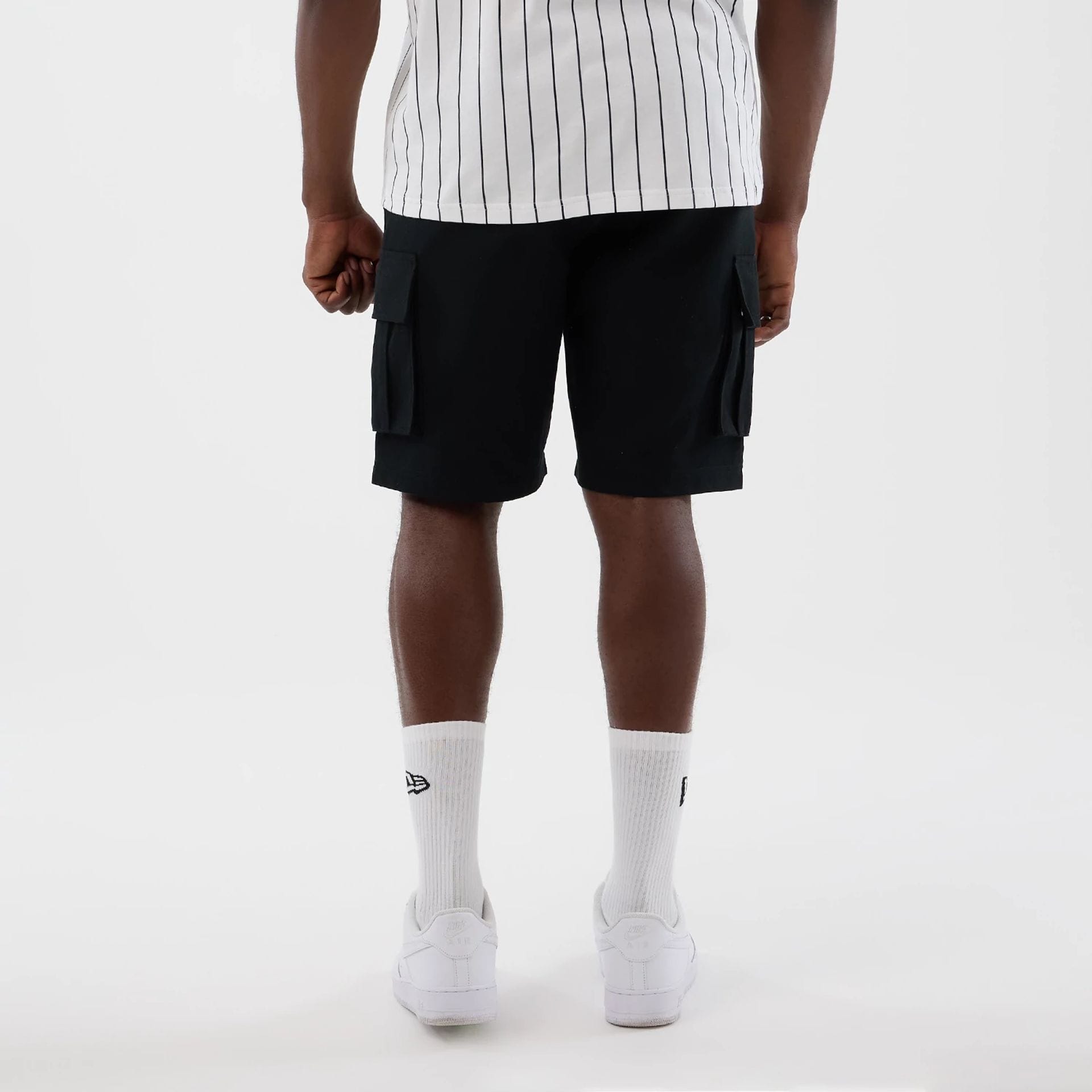 The model is wearing this New Era Cargo Shorts in black. 2