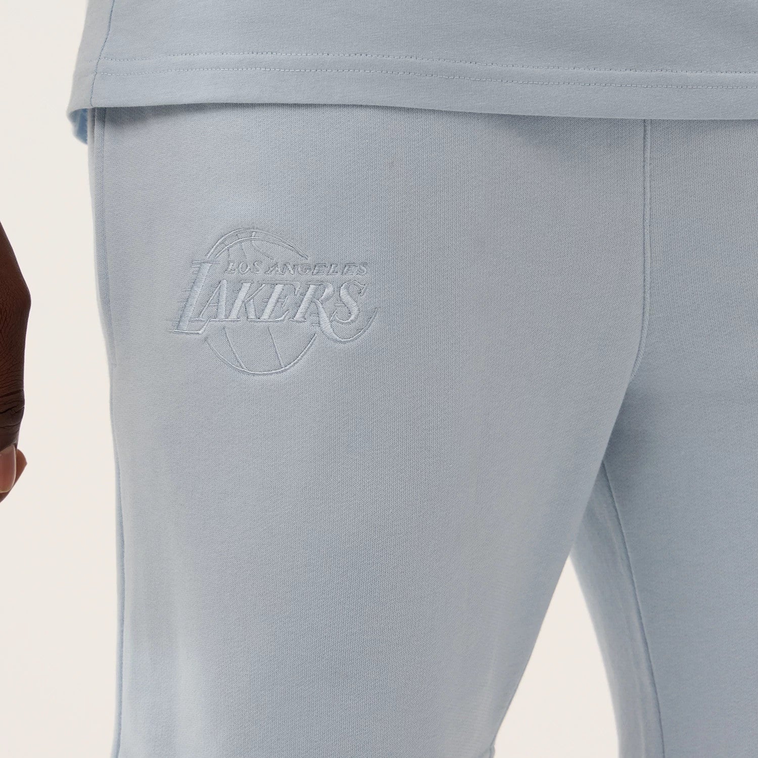 The model is wearing this NBA League Essential LA Lakers Shorts in pastel blue. 3
