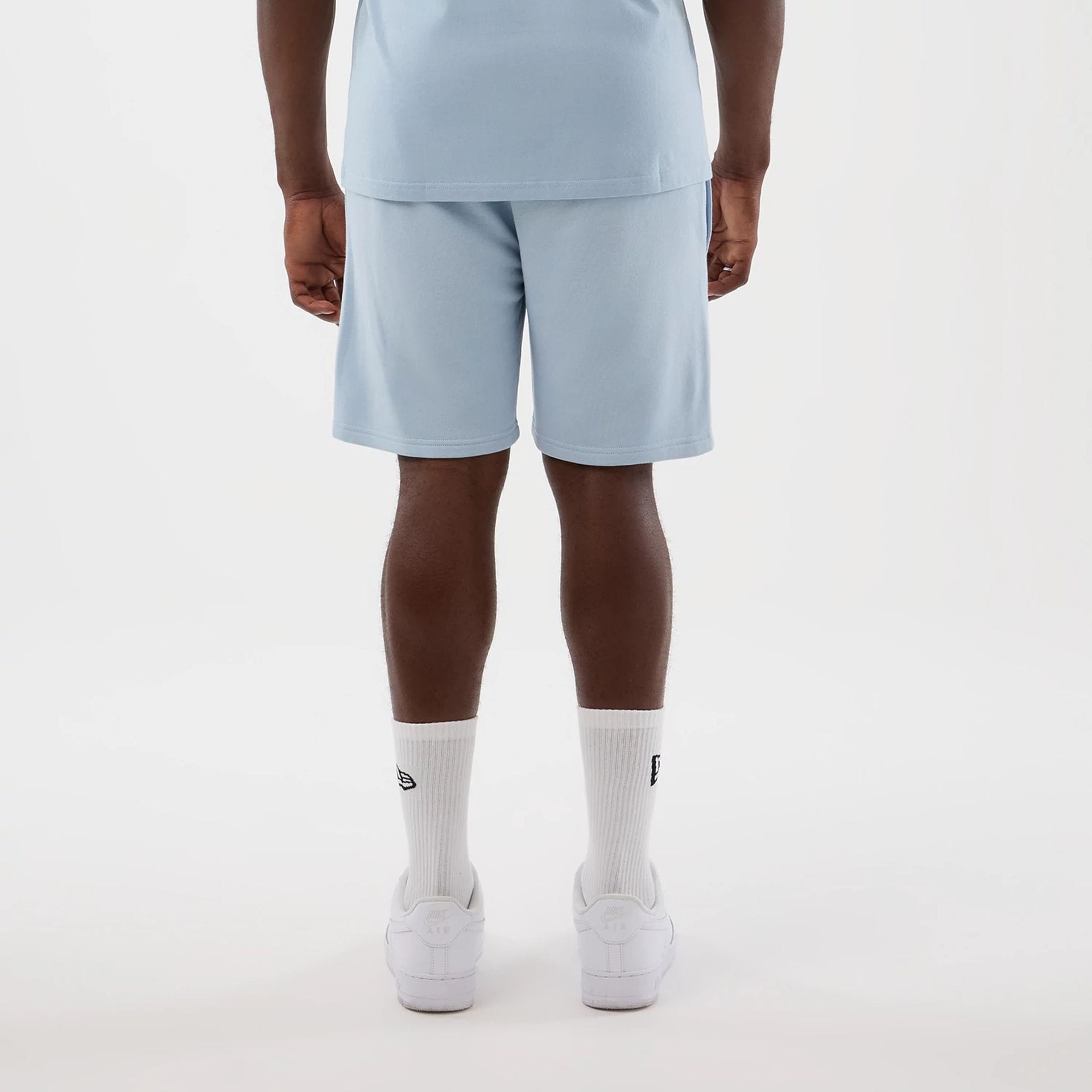 The model is wearing this NBA League Essential LA Lakers Shorts in pastel blue. 2