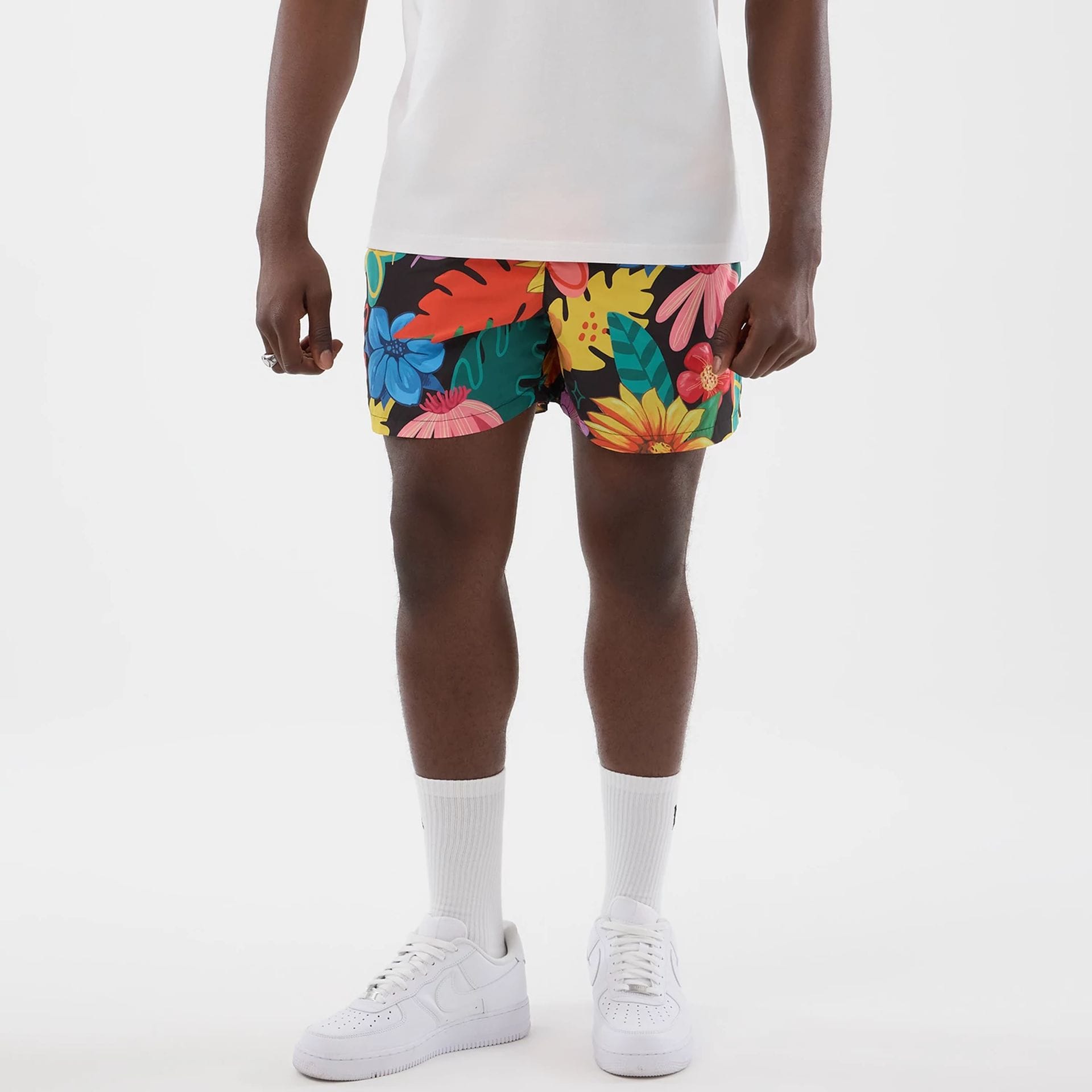 The model is wearing this New Era Floral Swimming Shorts in black. 1