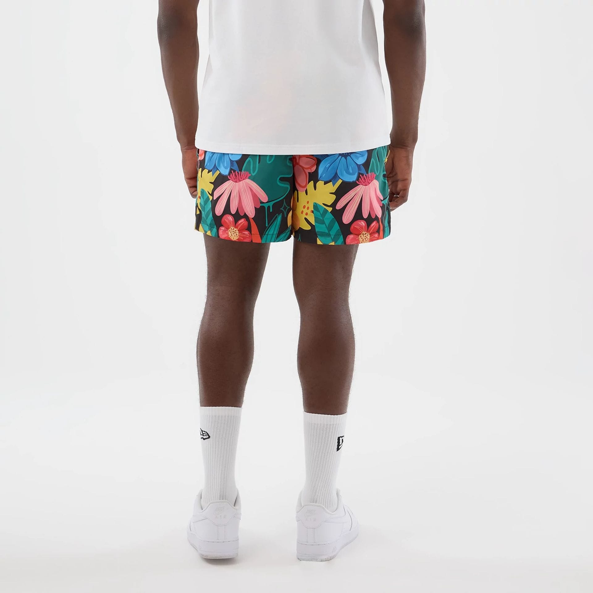 The model is wearing this New Era Floral Swimming Shorts in black. 2