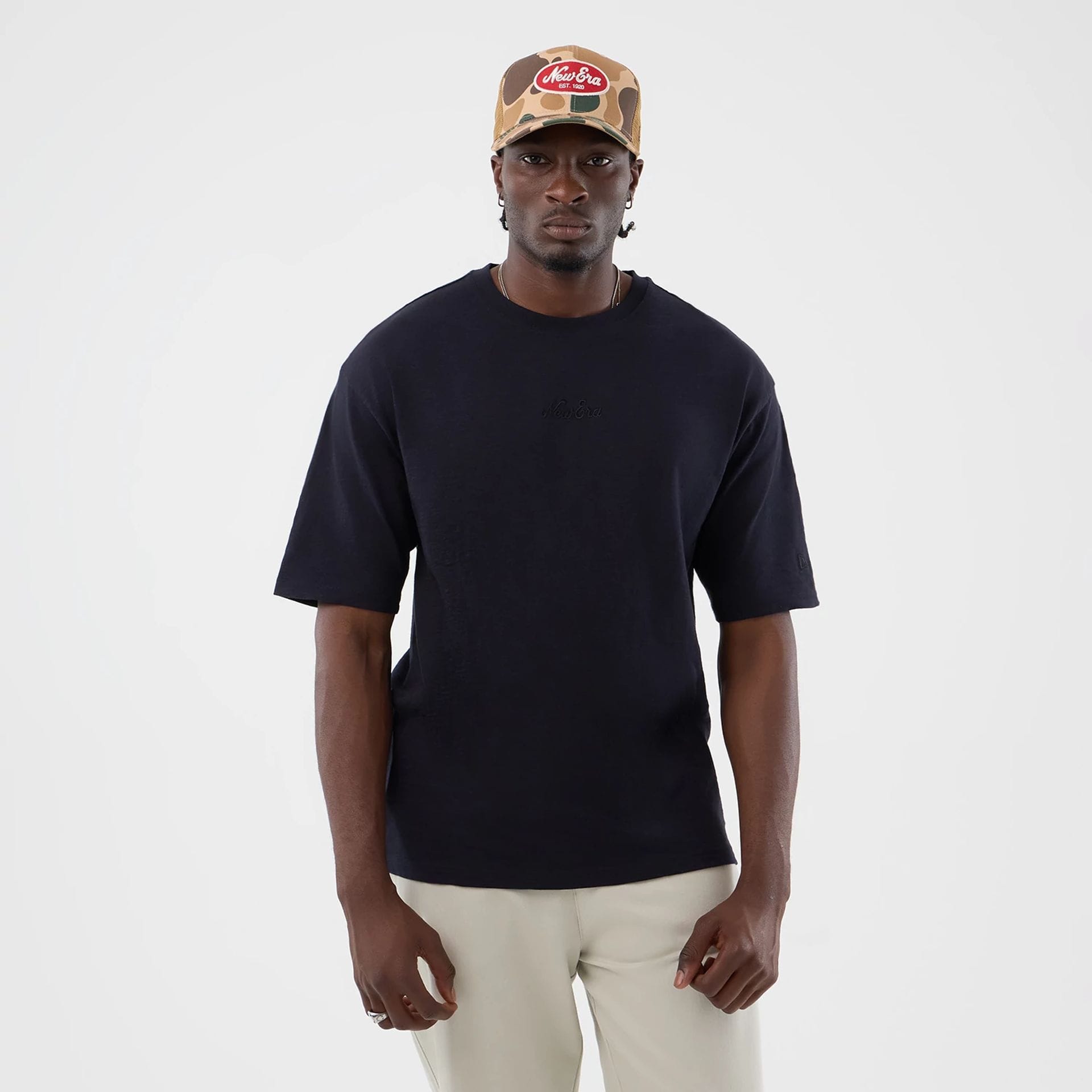 The model is wearing this New Era Slub Oversized T-Shirt in navy. 1