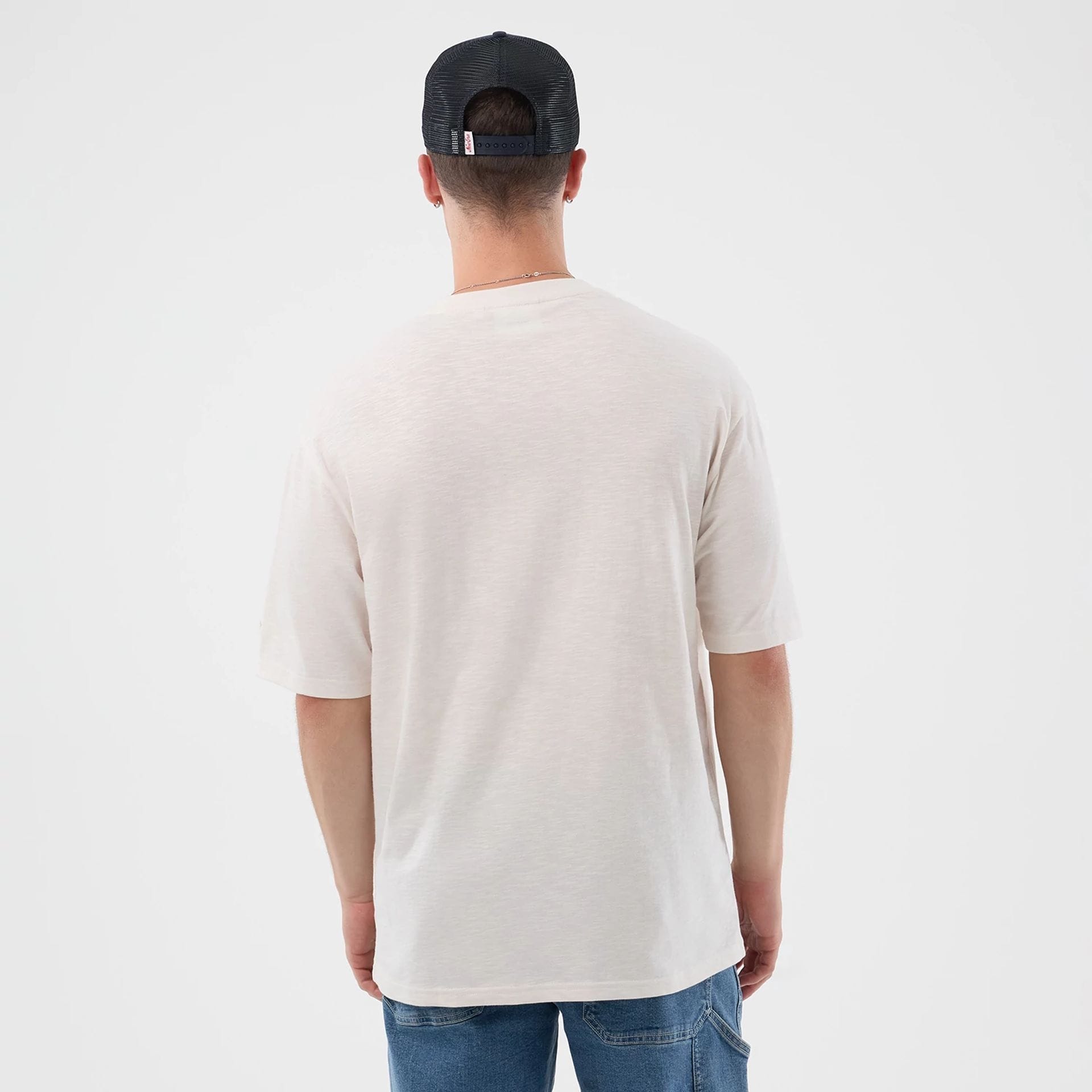 The model is wearing this New Era Slub Oversized T-Shirt in open white. 2