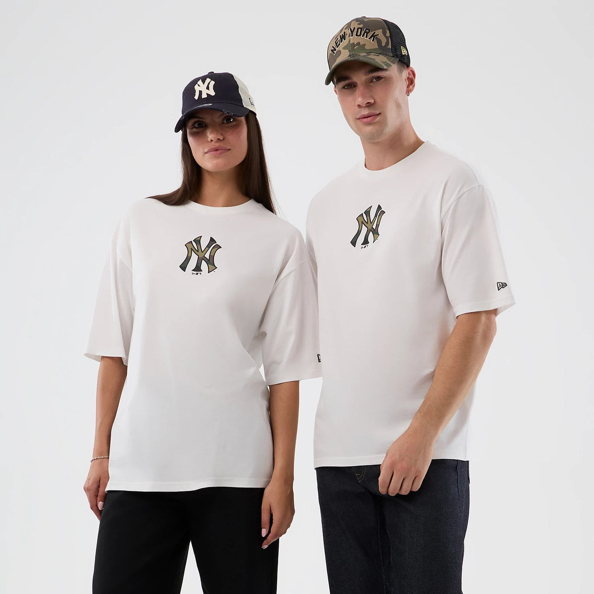 New Era New York Yankees MLB Infill White Oversized T-Shirt, on-model view showing the New York Yankees logo with a distinctive infill design on the chest, paired with matching black jeans and styled with a black and white New Era cap.