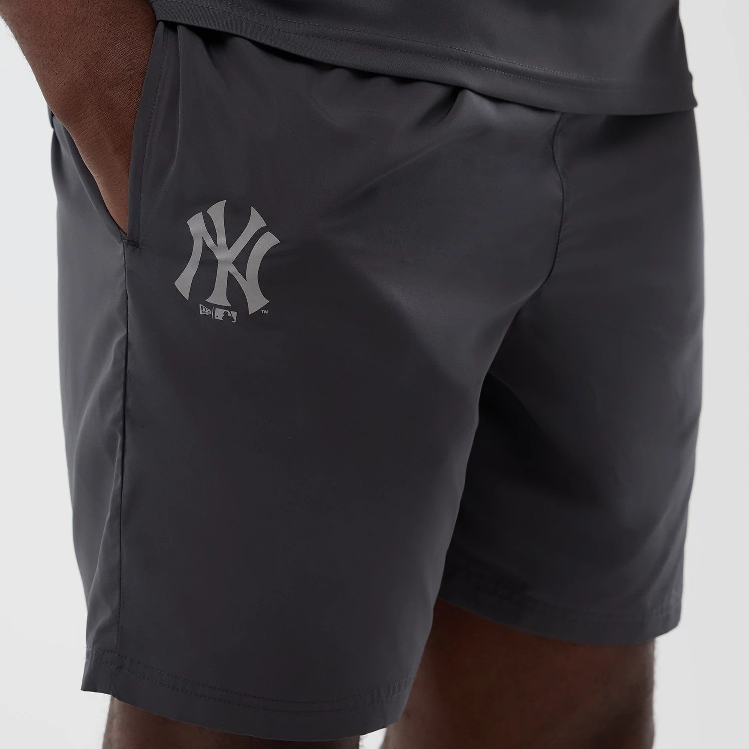 The model is wearing this MLB Core Plus New York Yankees Shorts in dark grey. 4