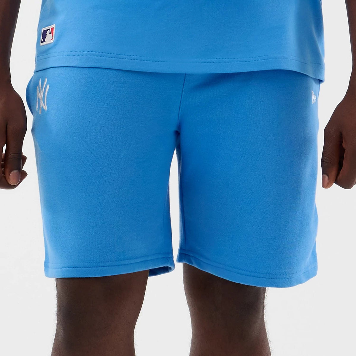 The model is wearing this MLB League Essential New York Yankees Shorts in pastel blue. 7
