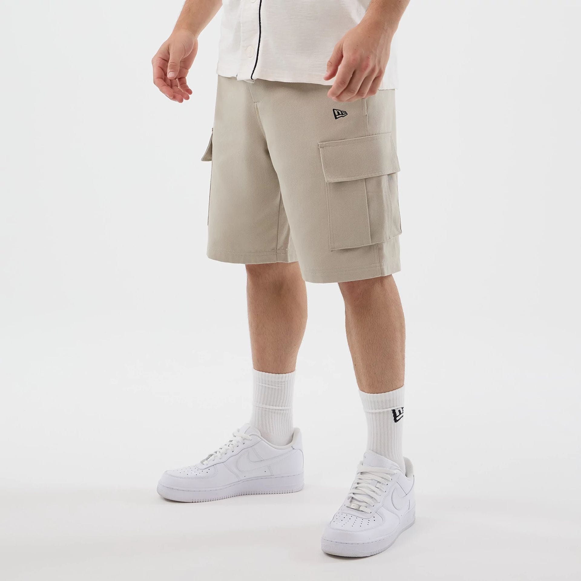 The model is wearing this New Era Cargo Shorts in light beige. 1