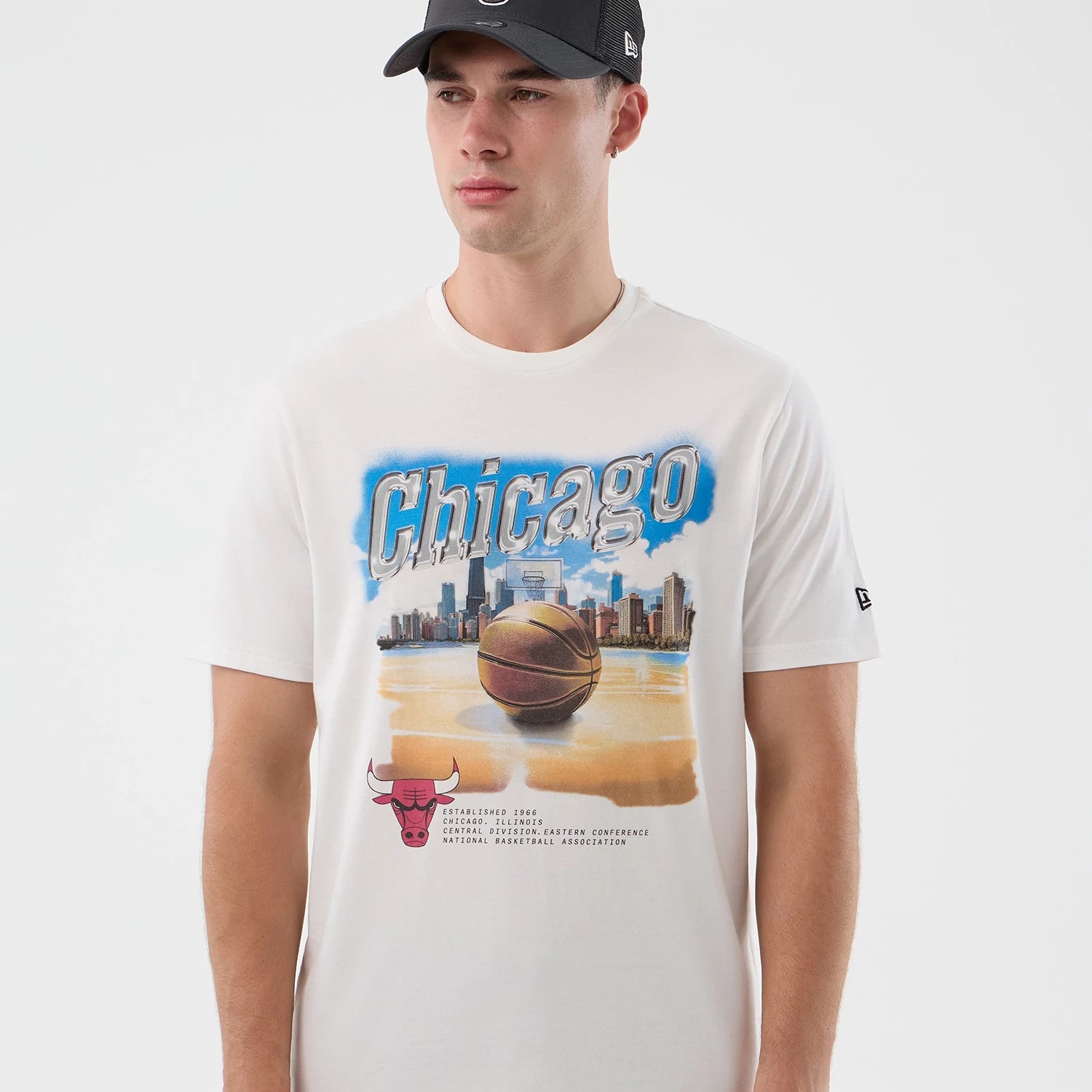 The model is wearing this NBA Beach Graphic Chicago Bulls T-Shirt in white. 3