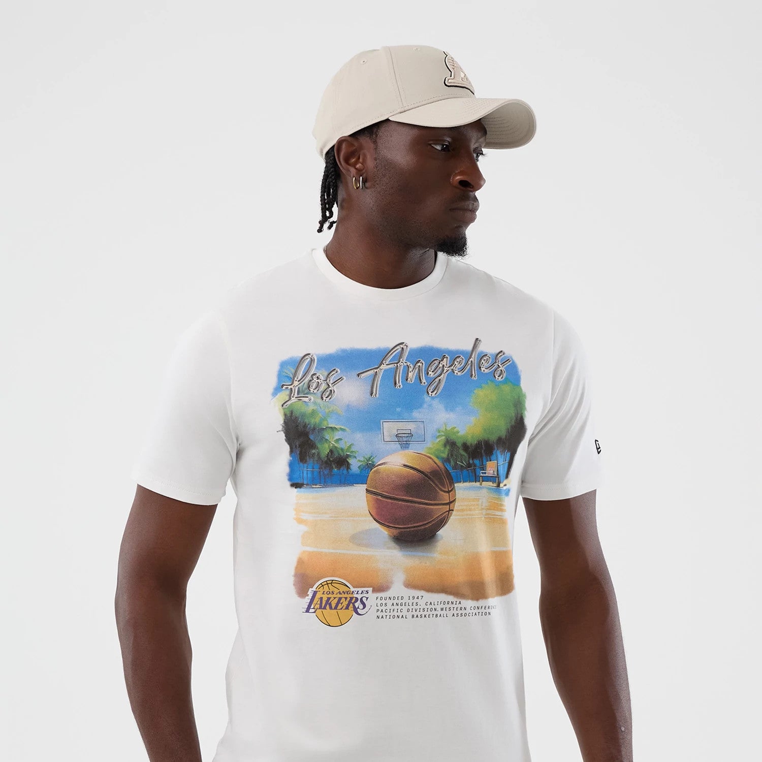 The model is wearing this NBA Beach Graphic LA Lakers T-Shirt in white. 3