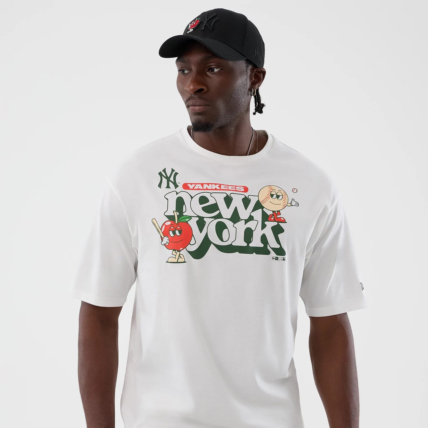 The model is wearing this MLB Icon Graphic New York Yankees T-Shirt in white. 3