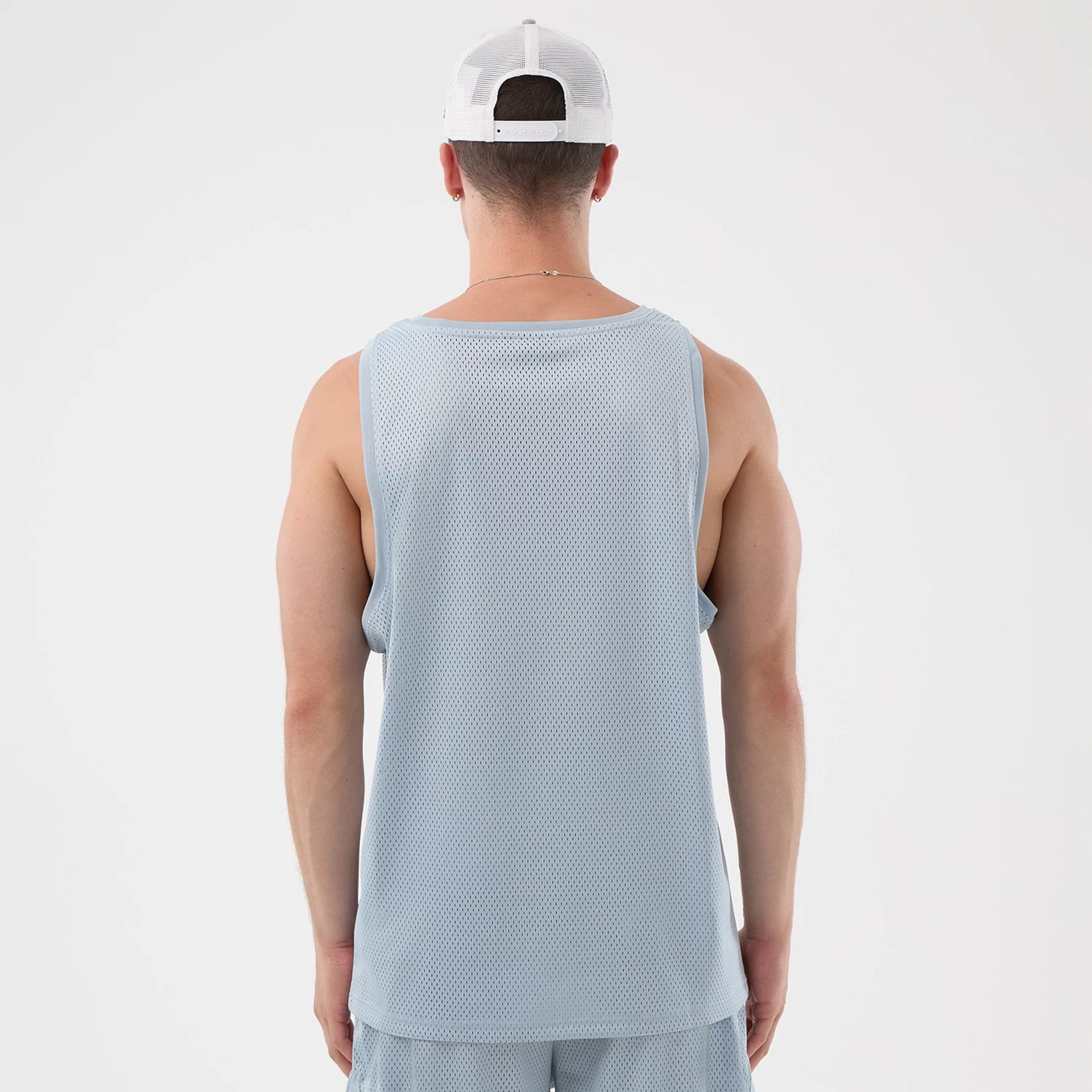 The model is wearing this New Era Mesh Oversized Tank Top in pastel blue. 2