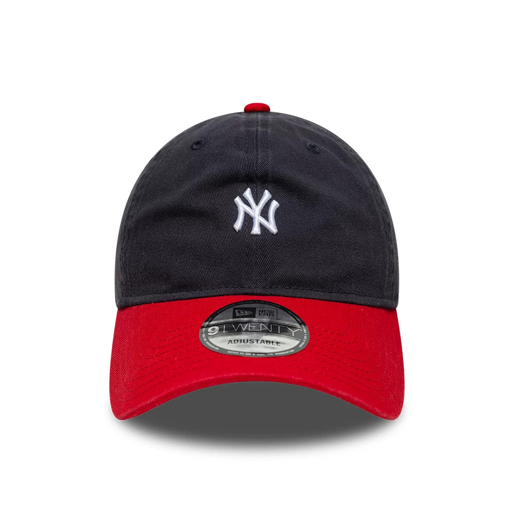 New York Yankees MLB Washed Contrast Navy New Era 9TWENTY Adjustable Cap, front view showing the white embroidered NY logo on the navy crown, the red curved visor with a 9TWENTY size sticker, and a matching red top button.