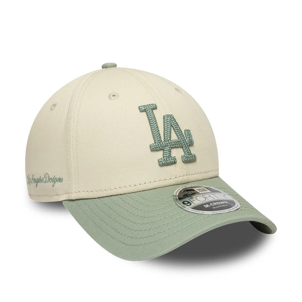 LA Dodgers MLB Side Script Cream New Era 9FORTY M-Crown Adjustable Cap, three-quarter view showing a raised green embroidered LA logo on the front panels, sage green curved visor, and 9FORTY size sticker on top of the visor.