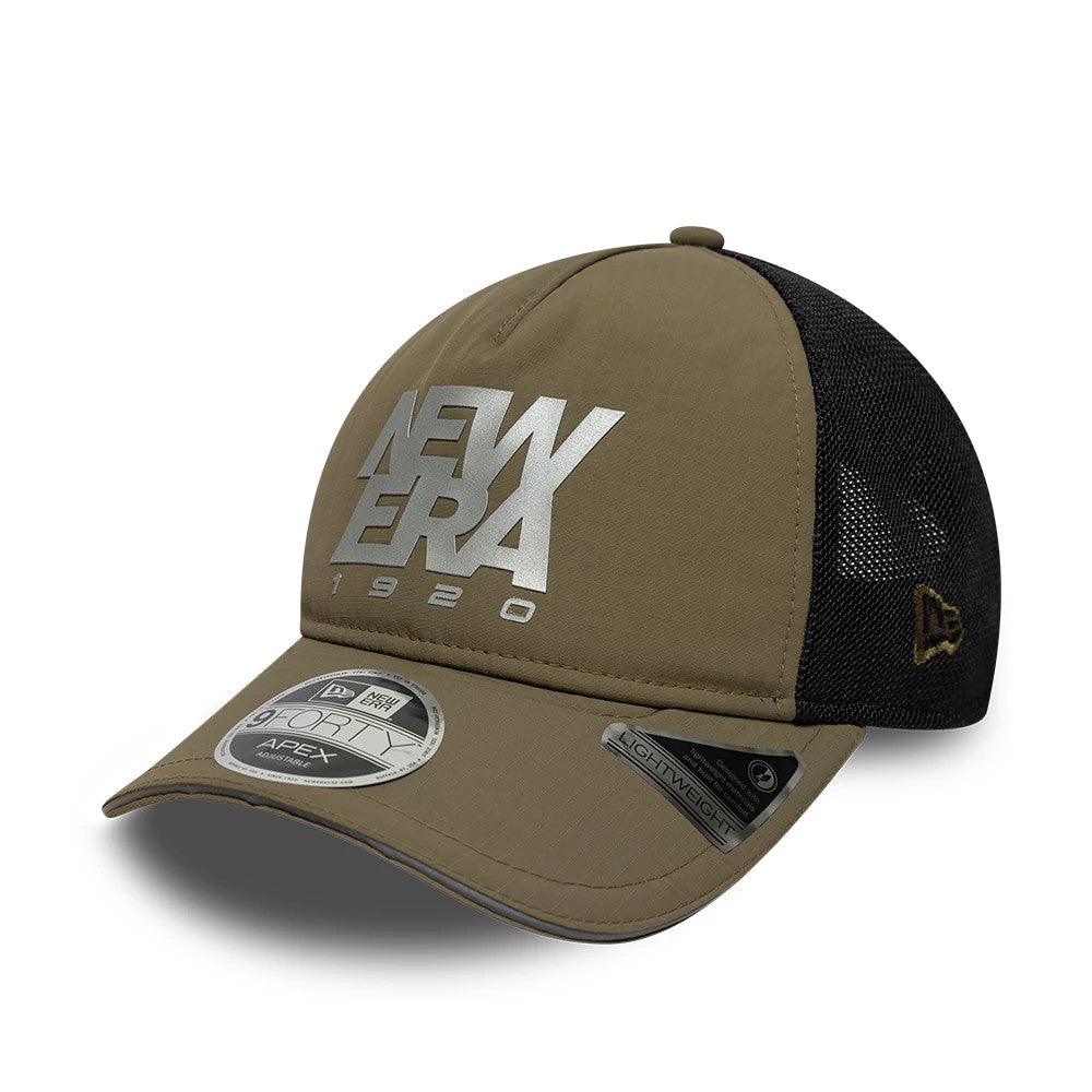 New Era Performance Green 9FORTY M-Crown A-Frame Trucker Adjustable Cap, front view showing a silver New Era 1920 logo in raised embroidery on the structured green front panel, curved visor with a 9FORTY size sticker, and black mesh side panels.