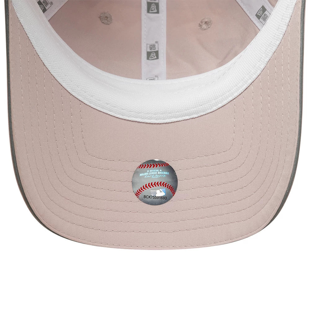 New Era New York Yankees Womens MLB Mesh Pastel Pink Pony Tail Cap, inside view showing grey undervisor with detailed stitching, white sweatband for comfort, and official MLB authentication sticker placed centrally.