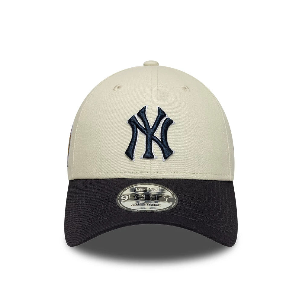 New York Yankees MLB World Series Patch Cream New Era 9FORTY Adjustable Cap, front view showing a navy blue raised embroidered Yankees logo on the cream front panel, with a black curved visor and 9FORTY size sticker on the top.