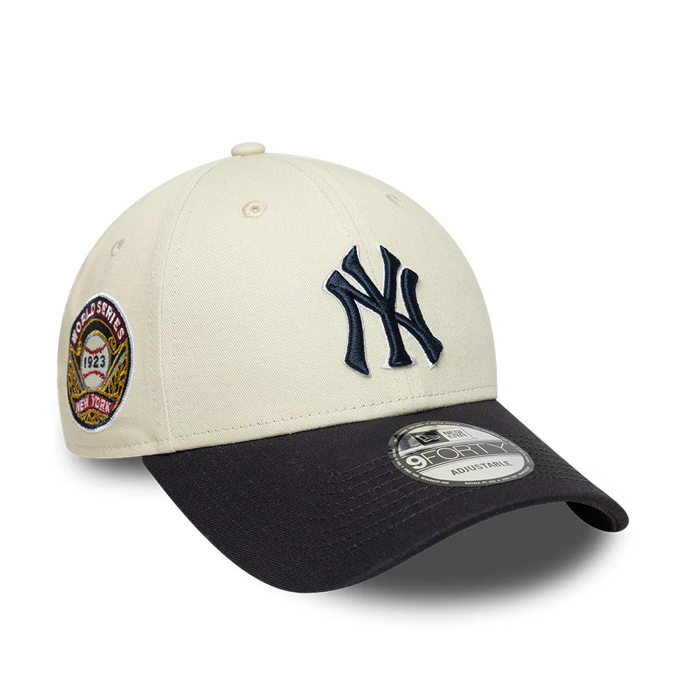 New York Yankees MLB World Series Patch Cream New Era 9FORTY Adjustable Cap, three-quarter view showing the navy blue embroidered NY logo on the front panel, a 1923 World Series patch on the left side.