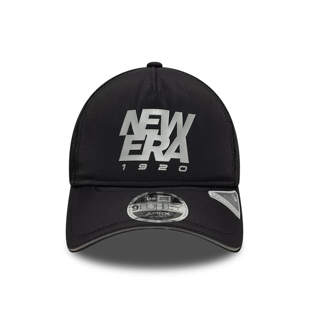 New Era Performance Black New Era 9FORTY M-Crown A-Frame Trucker Adjustable Cap, front view showing the raised silver New Era logo on the black front panel, curved black visor with 9FORTY size sticker, and mesh back panels.