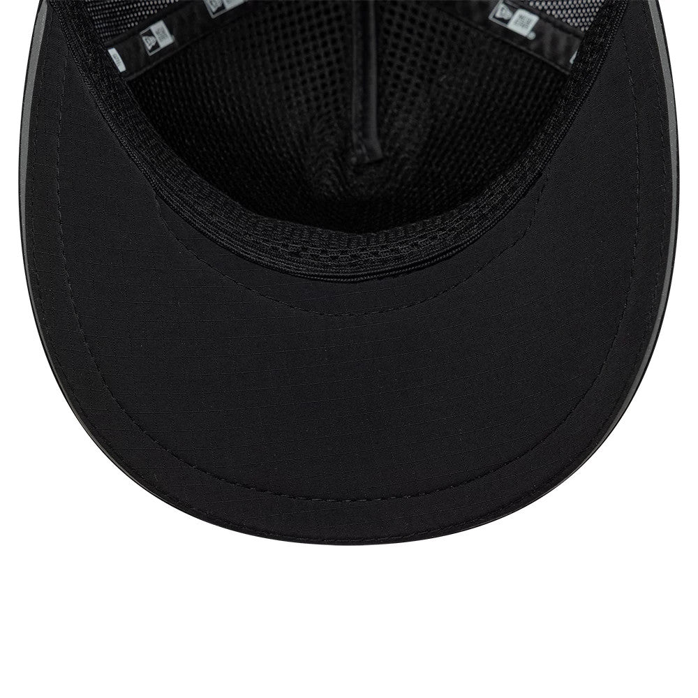 New Era Performance Black 9FORTY M-Crown A-Frame Trucker Adjustable Cap, inside view showing the black undervisor, with black mesh lining inside the crown and black seam taping featuring the New Era logo.