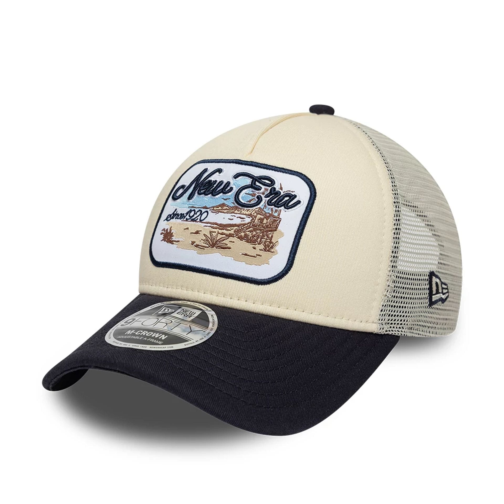 Pictured is this New Era 9FORTY M-Crown A-Frame Trucker cap in light beige. 1