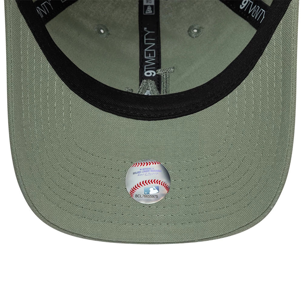 LA Dodgers Womens MLB Linen Pastel Green New Era 9TWENTY Adjustable Cap, inside view showing the black sweatband surrounding the light olive green undervisor, with black taping marked with 9TWENTY logos and an MLB logo sticker on the visor.