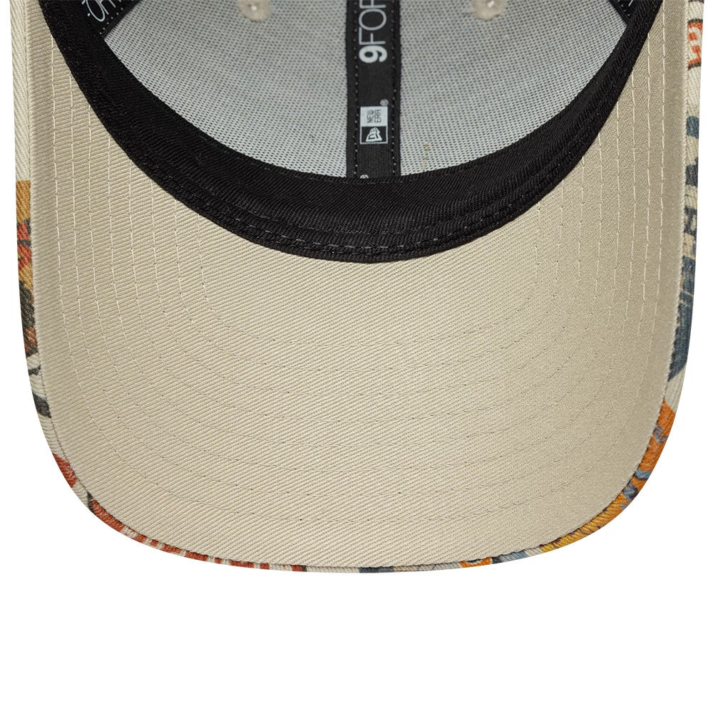 Youth New Era Location Light Beige 9FORTY Adjustable Cap, inside view showing the beige undervisor with colourful patterned edges, a black sweatband, and black taping running across the crown with a 9FORTY size sticker.