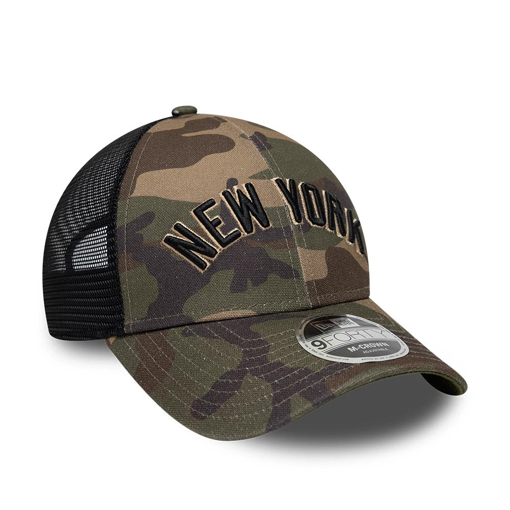 New York Yankees MLB Wordmark Woodland Camo New Era 9FORTY M-Crown Adjustable Cap, three-quarter view showing the black embroidered New York lettering on the front panels, curved camo visor, and 9FORTY size sticker on the right side.